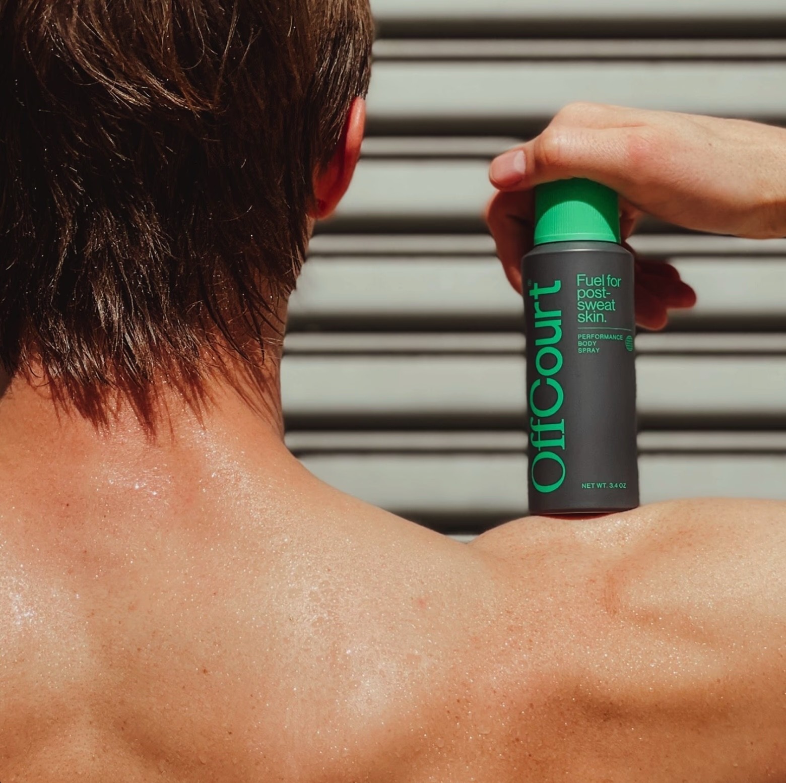 Offcourt Product Lifestyle Shot bottle on shoulder