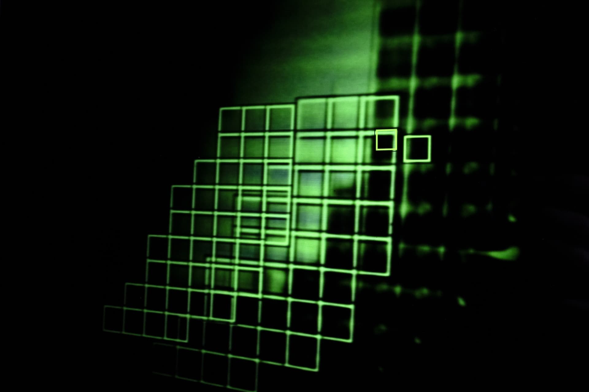 Dense cluster of green autofocus detection boxes creating geometric composition, camera attempting to focus on its own focusing mechanism displayed on screen