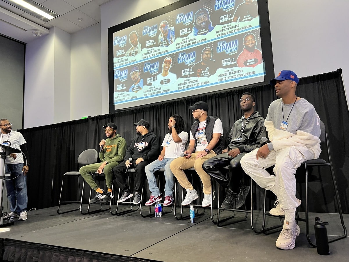 Jared Oluwa and other people on stage for a Sync Licensing Panel.