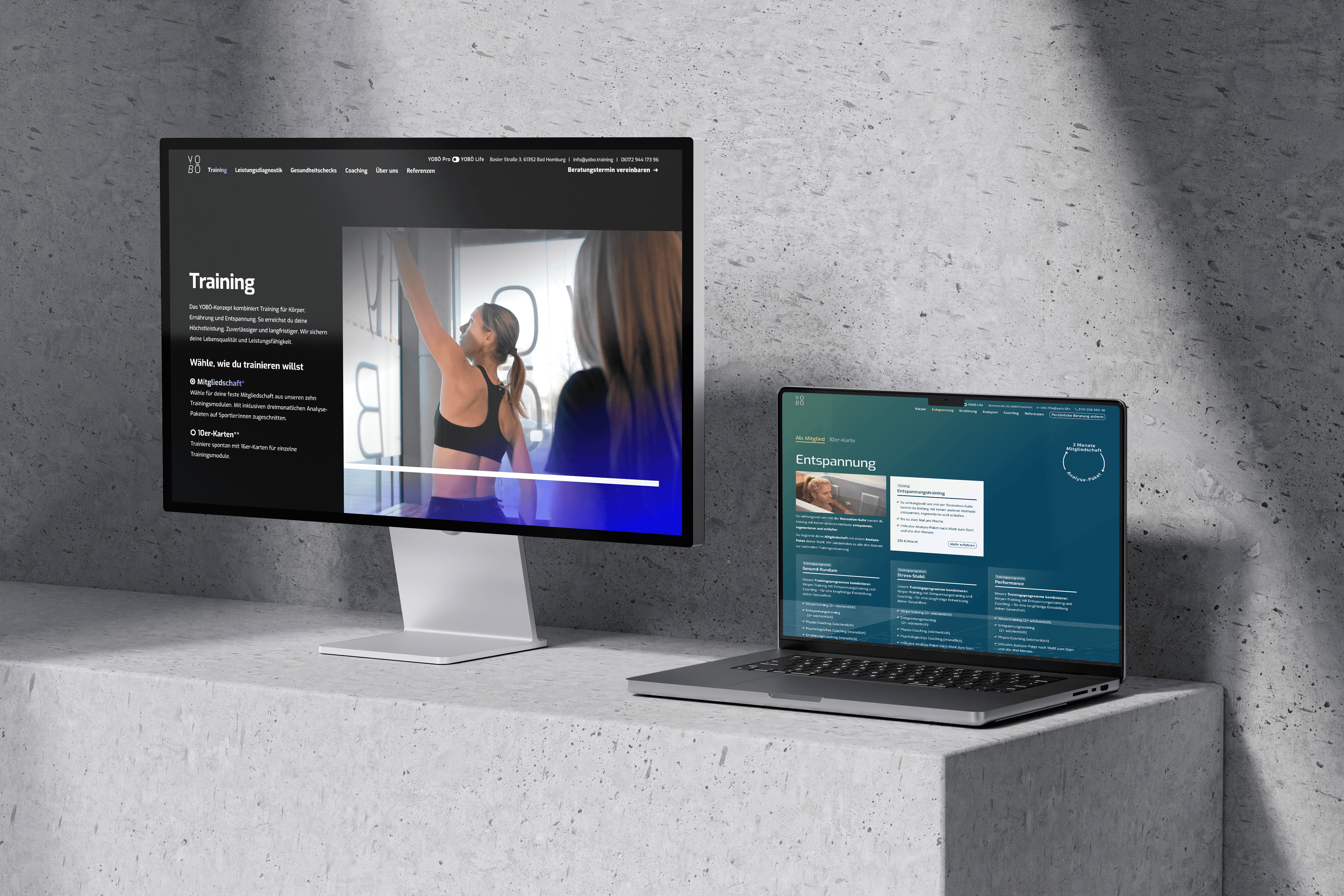 Ein Desktop-Monitor und ein Laptop, auf denen die YOBO-Website angezeigt wird.