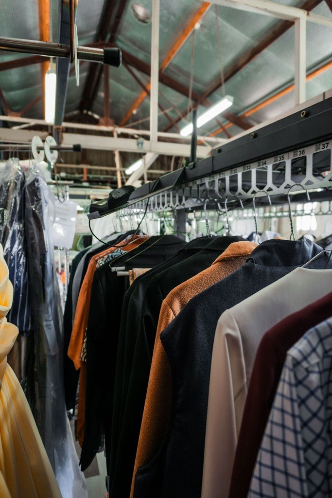 Pressed garments hanging in protective covers at Eclo dry cleaning Brisbane