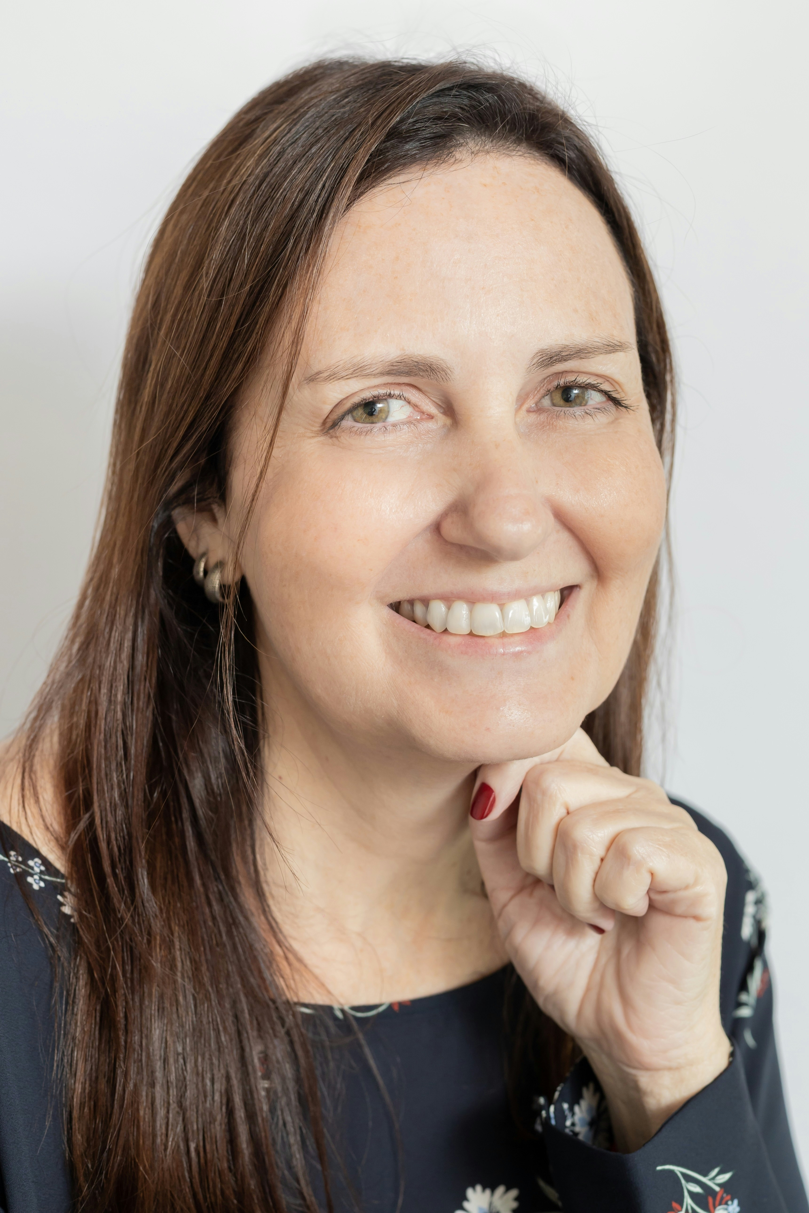 A smiling woman with long brown hair