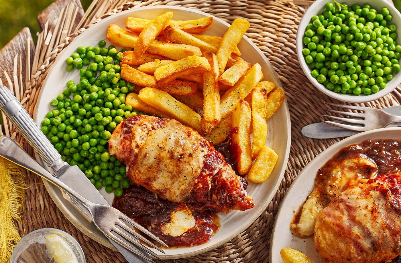 Chicken breast wrapped in bacon and smothered in tangy BBQ sauce. Topped with cheddar cheese and served with triple cooked chips & seasoned mash