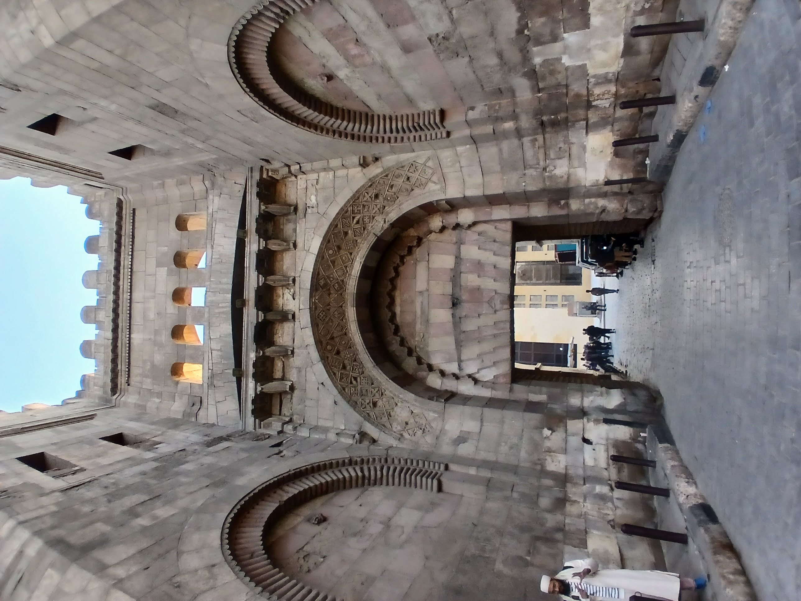 An image of one of a large gate, one of Fatimi Cairo. The gate is decorated with carvings and symbols from Fatimi times.