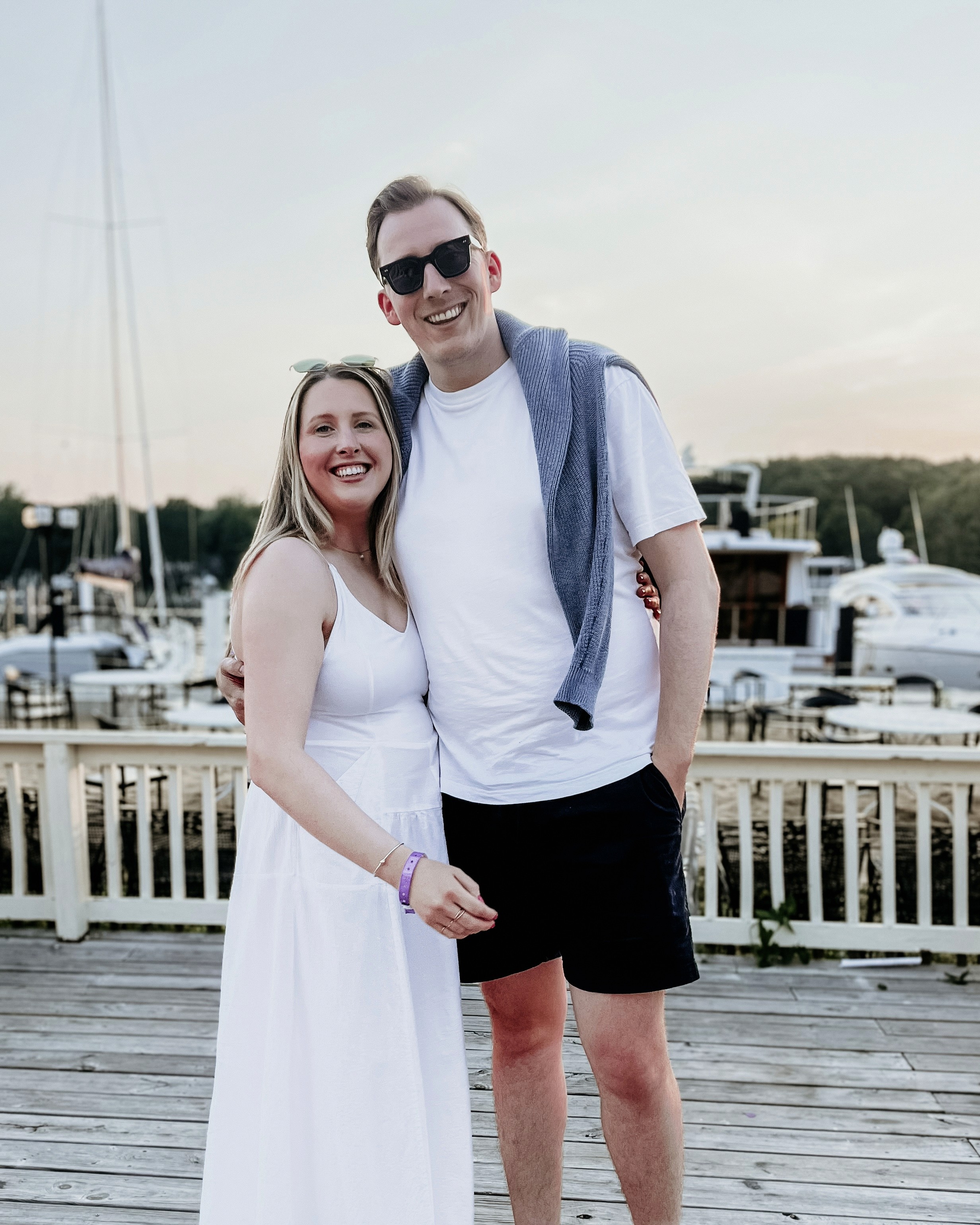 Green car under neon lights in a rainy city street