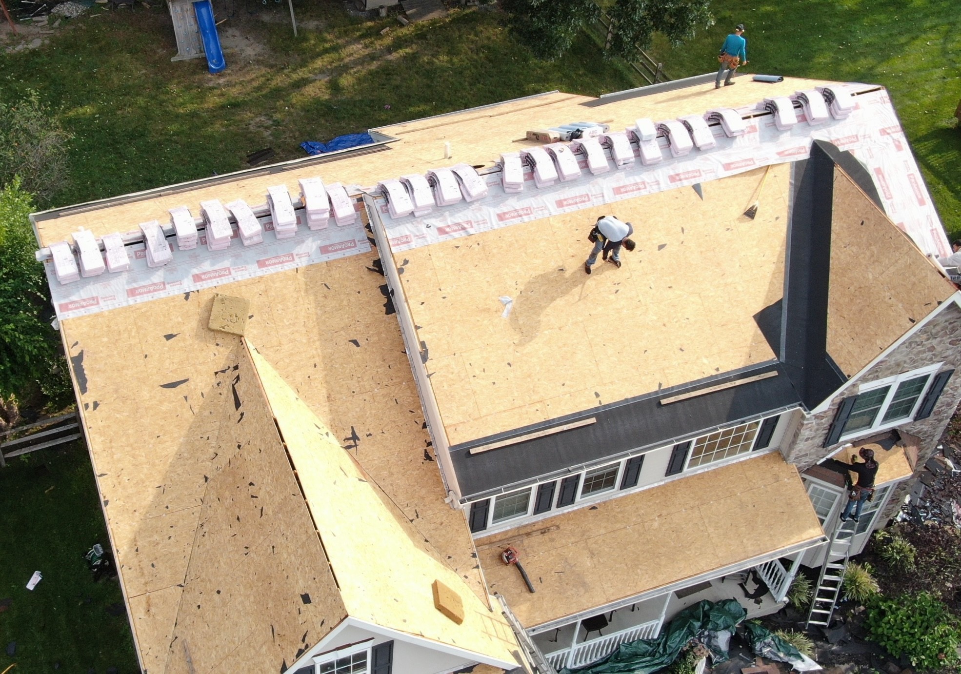 KCX roofers tear off shingles down to decking on residential roof