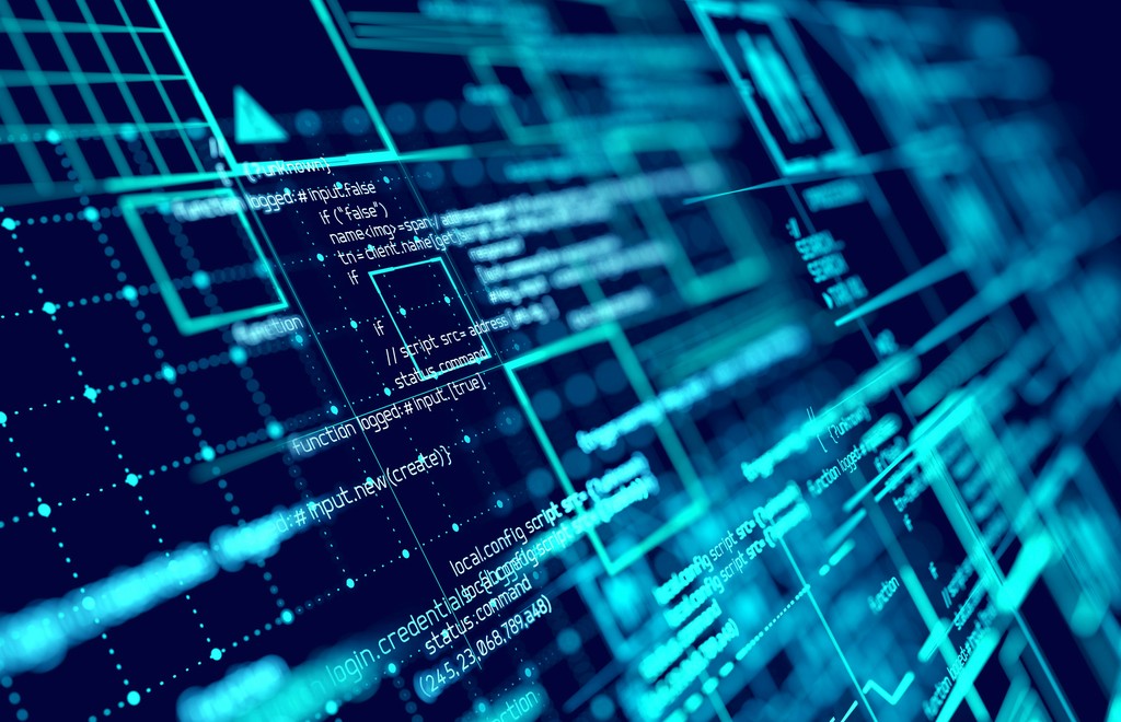 A desk with a laptop and an employee badge laying on top of it.