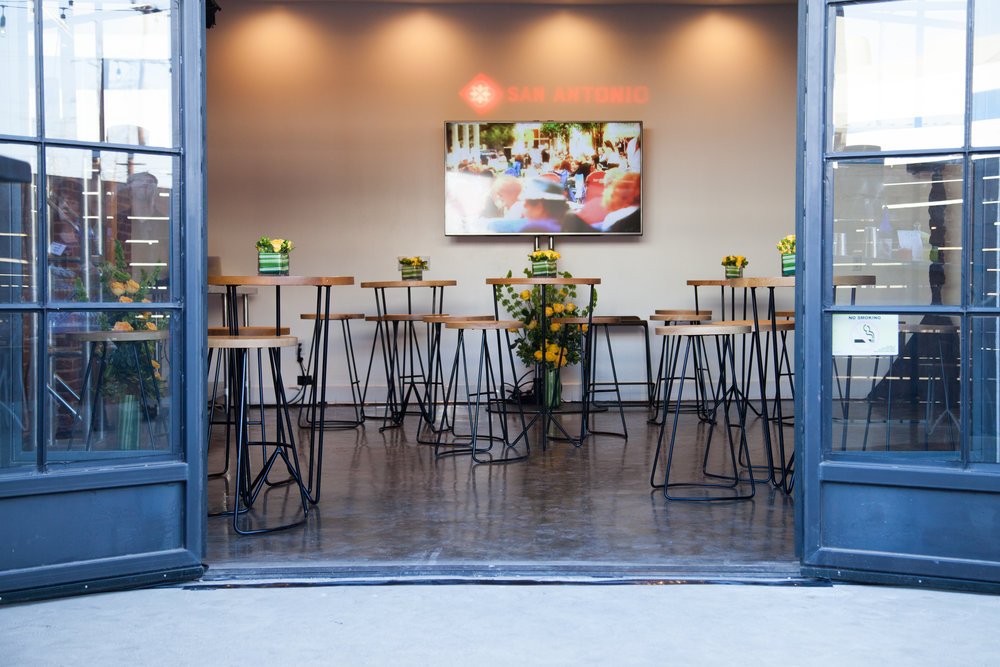 Crafted Kitchen tables and pendant lights seen through the open doors.