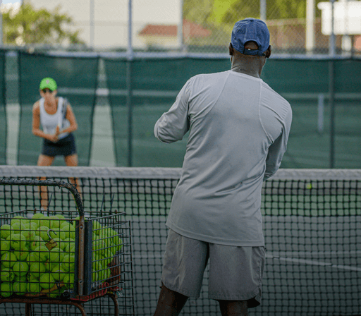 Professional mobile tennis coach giving private instructions at a client's home court in Virginia, United States