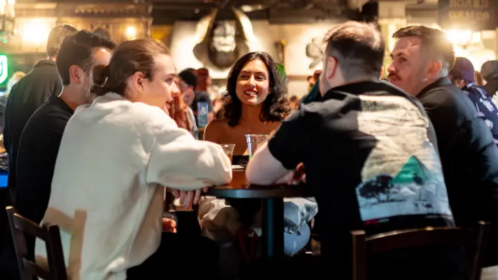 Group of people sitting at a cocktail table in the Tavern