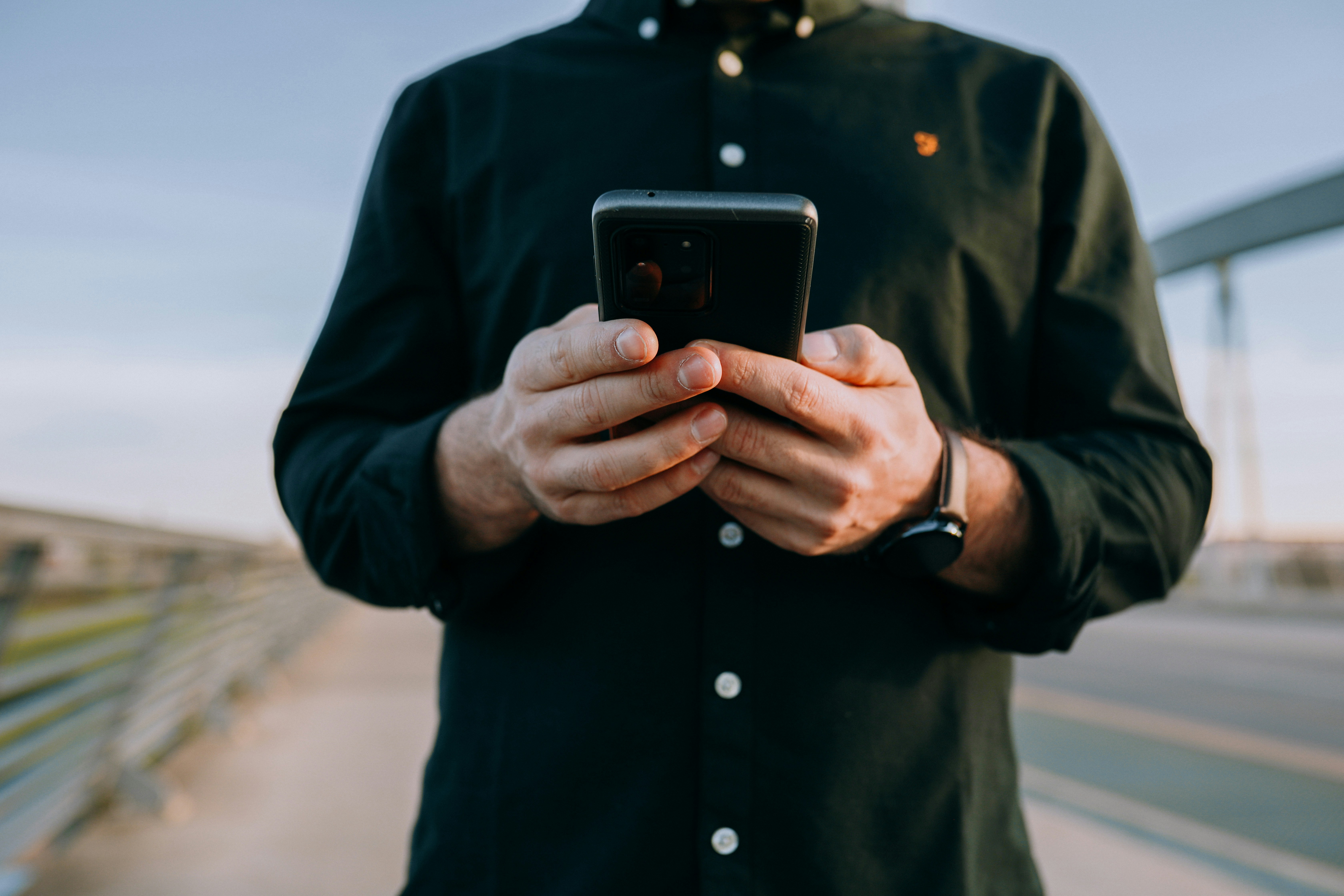 person looking at his phone - How To Clear Gmail Storage