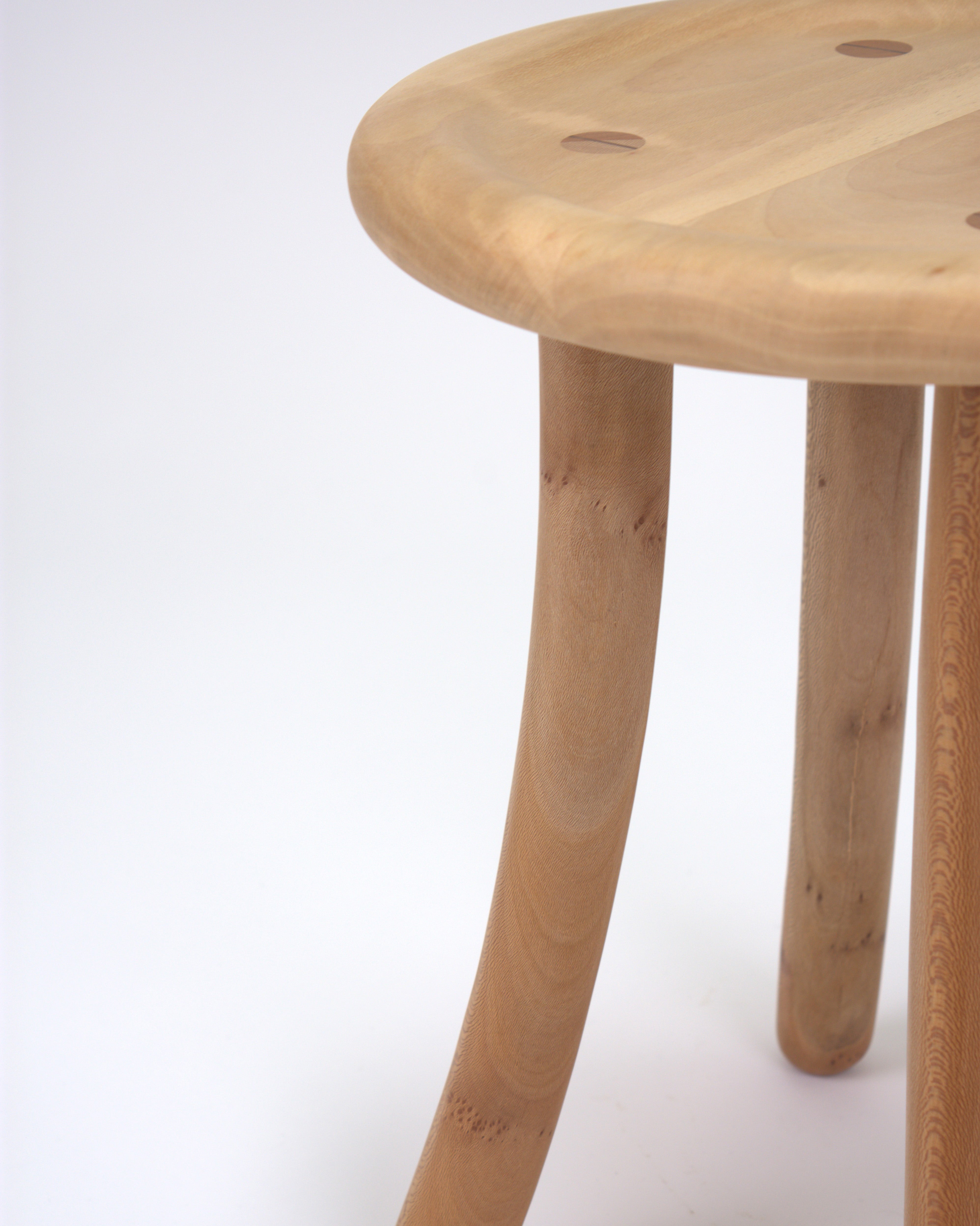 Wooden curved Luneta stool close-up on a white background