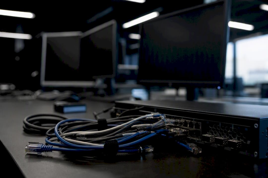 Close-up of network cables and hardware in dark workspace