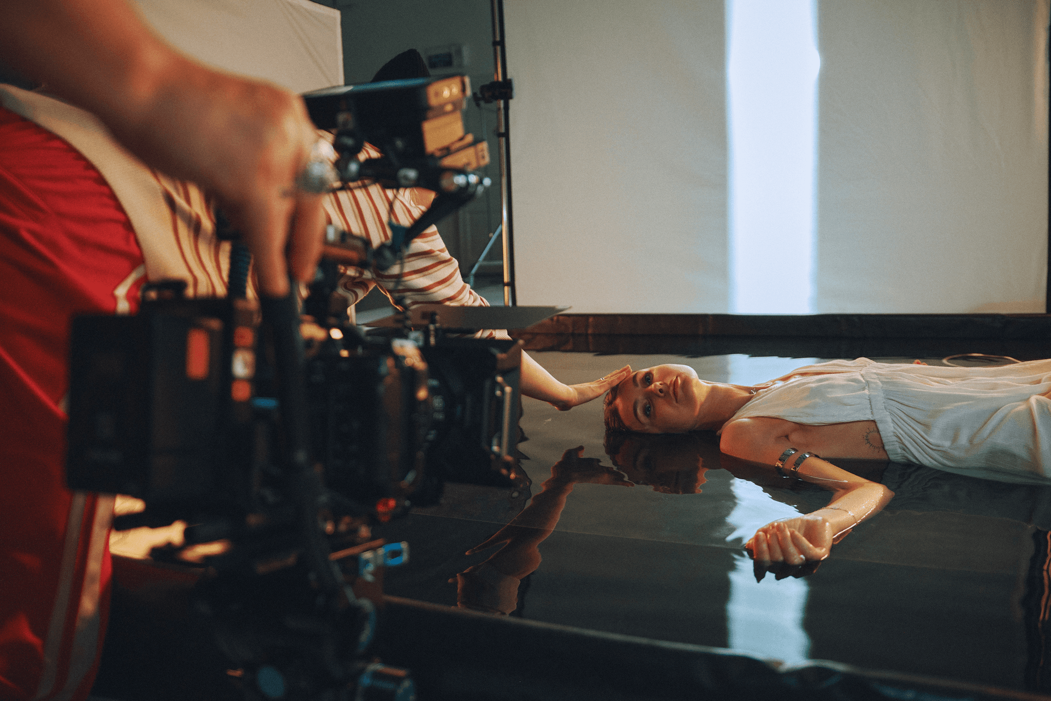 WA woman lying on the floor being filmed