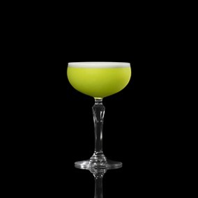 A closeup of a Irish Clover drink against a dark background.