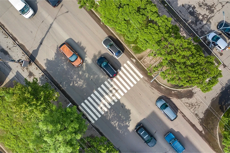 Overhead photo of a crosswalk with traffic suppporting content about injuries in pedestrian accidents in Stockton