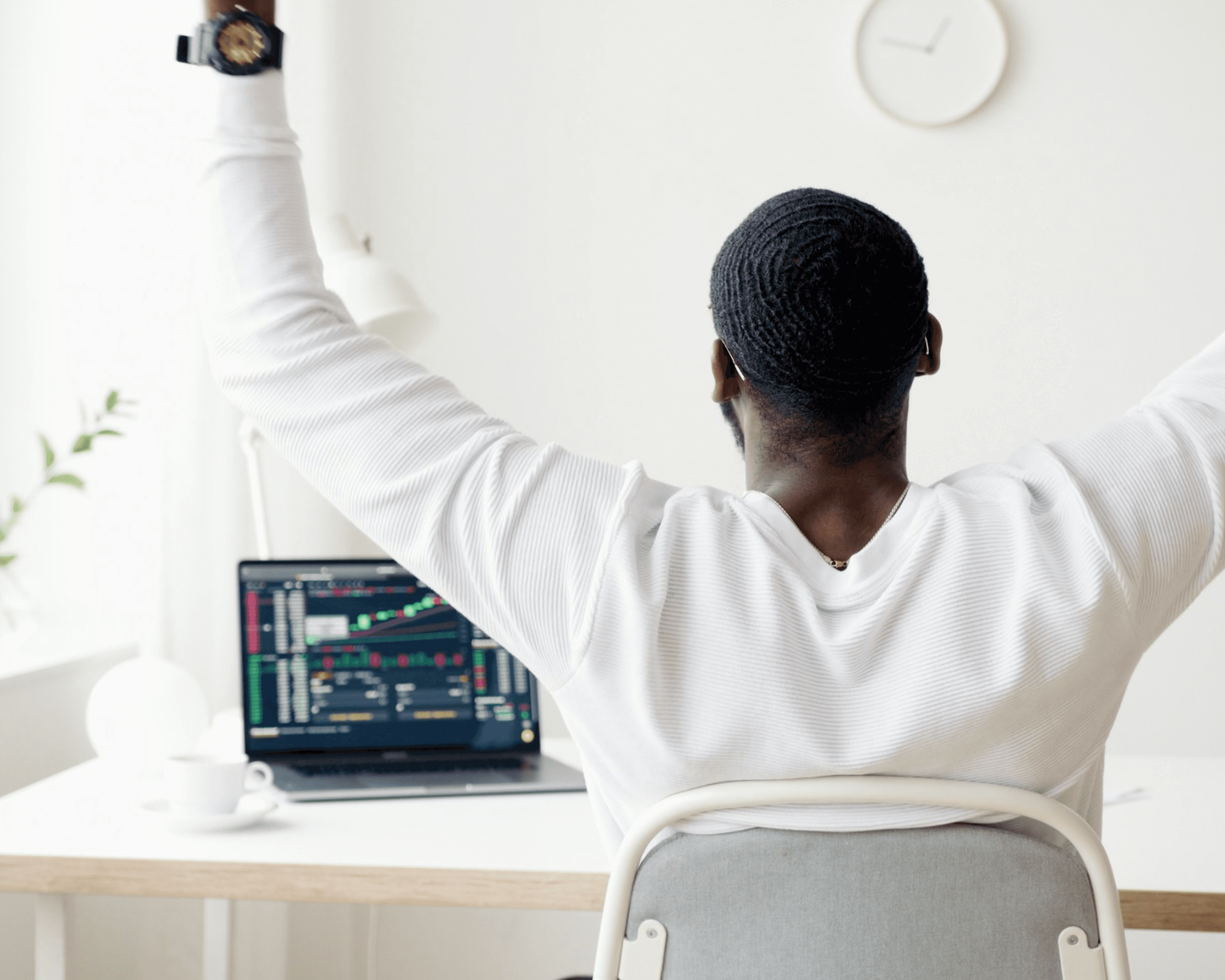 Photo of a West African business man celebrating in front of his laptop. Photo by Anna Nekrashevich.