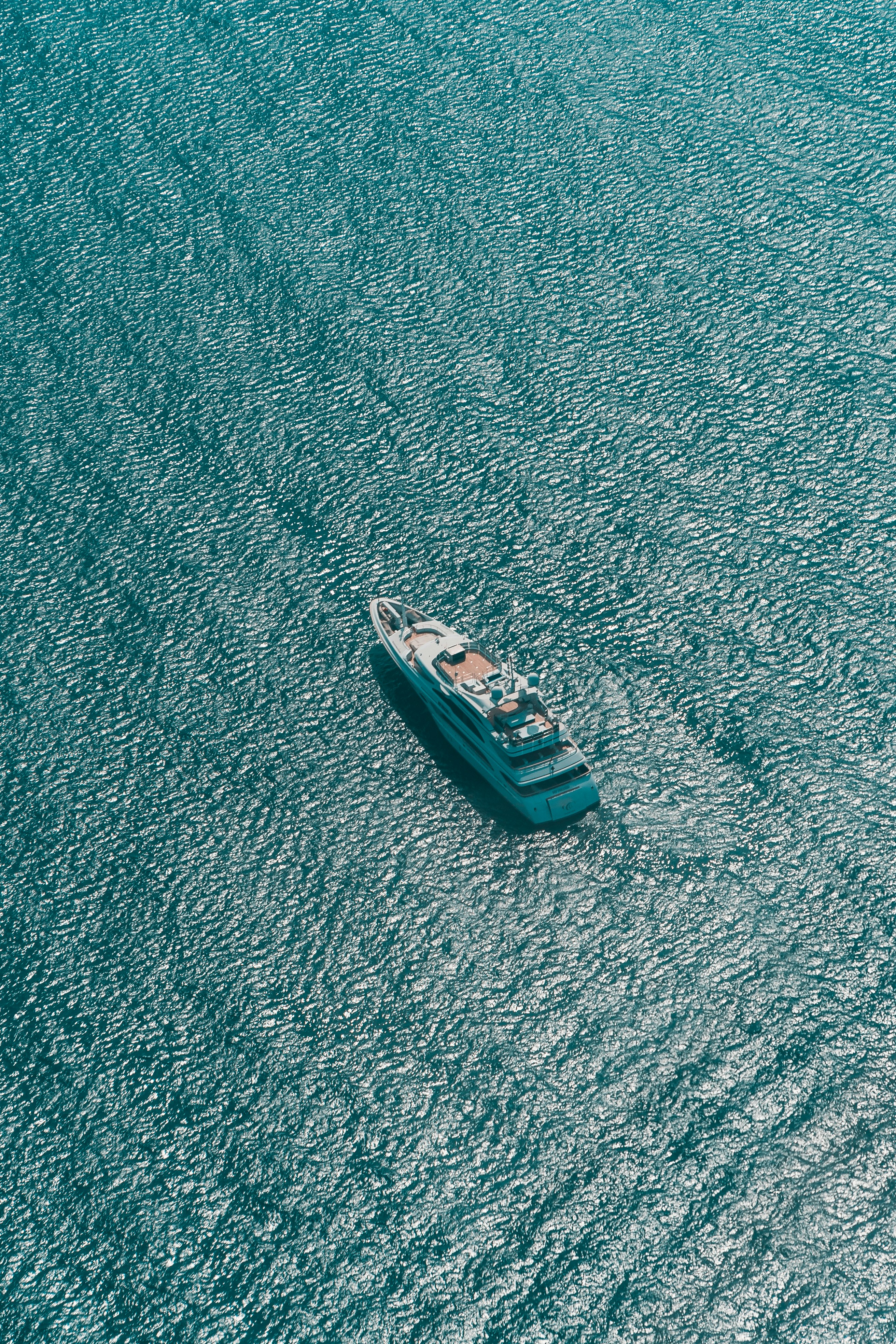 white and blue boat on blue textile