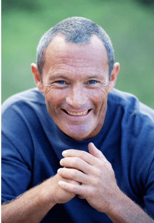 smiling woman wearing white and black pinstriped collared top