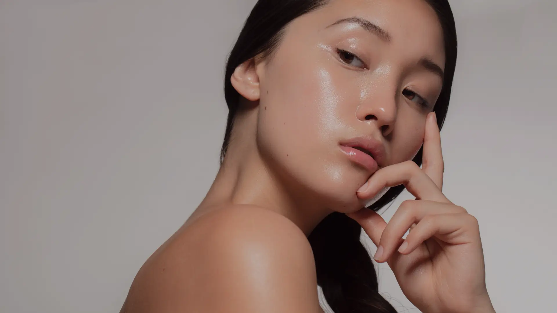Person wearing orange sunglasses with dramatic orange and red lighting effects creating an artistic portrait
