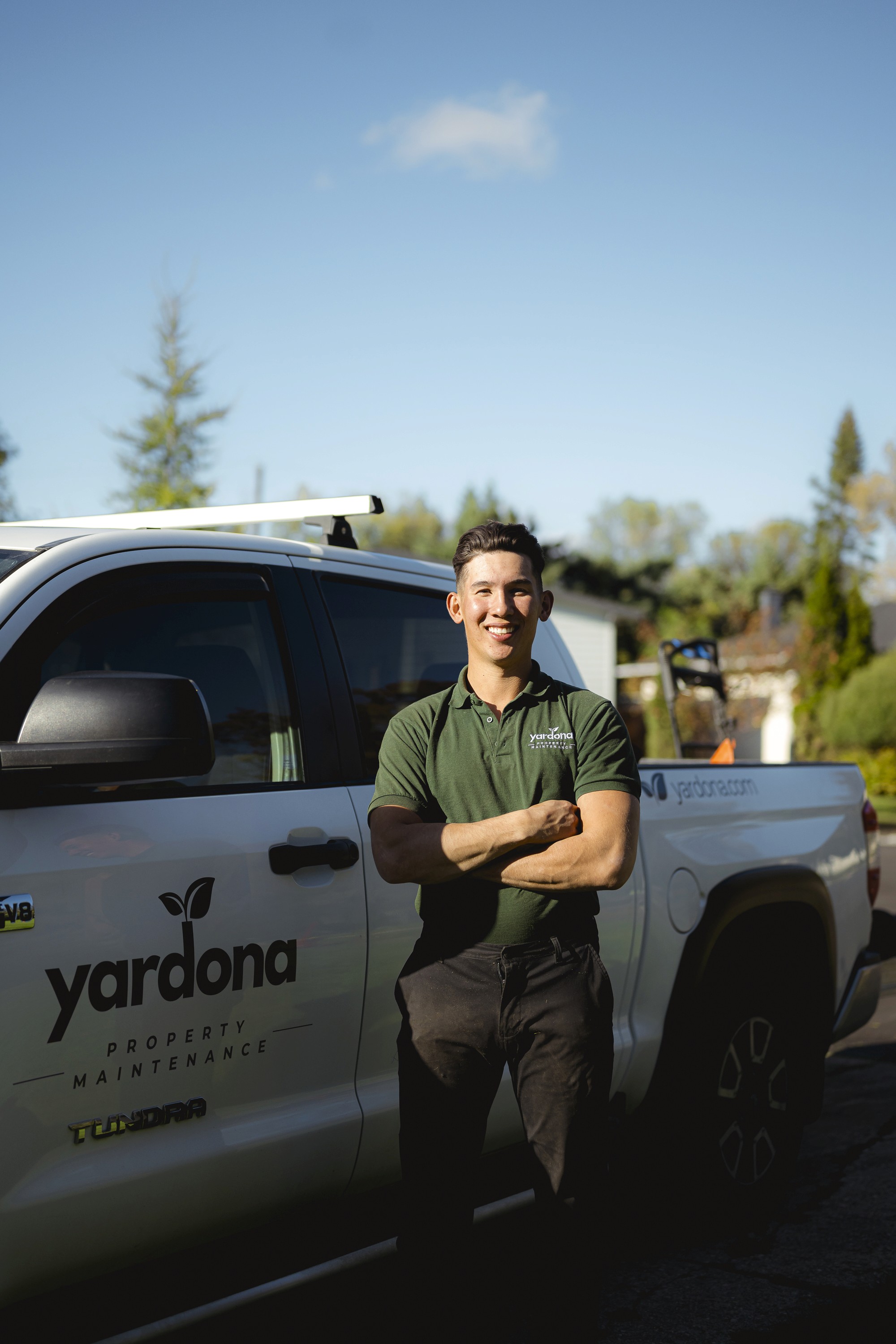 Lawncare technician in front of truck