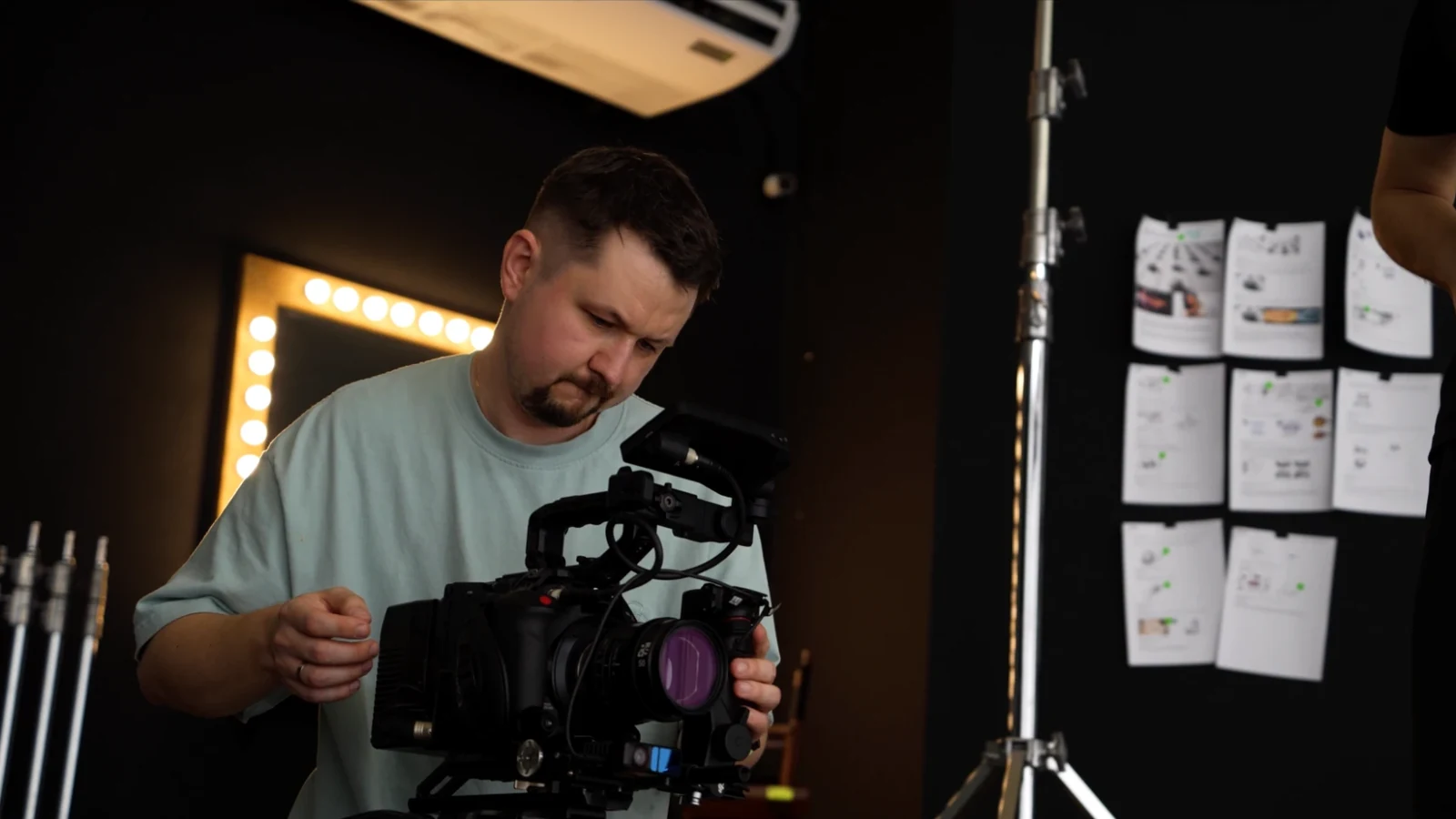 Producer preparing the camera rig next to the storyboard wall