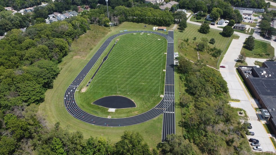Aerial view of an outdoor running track surrounding a grass field.