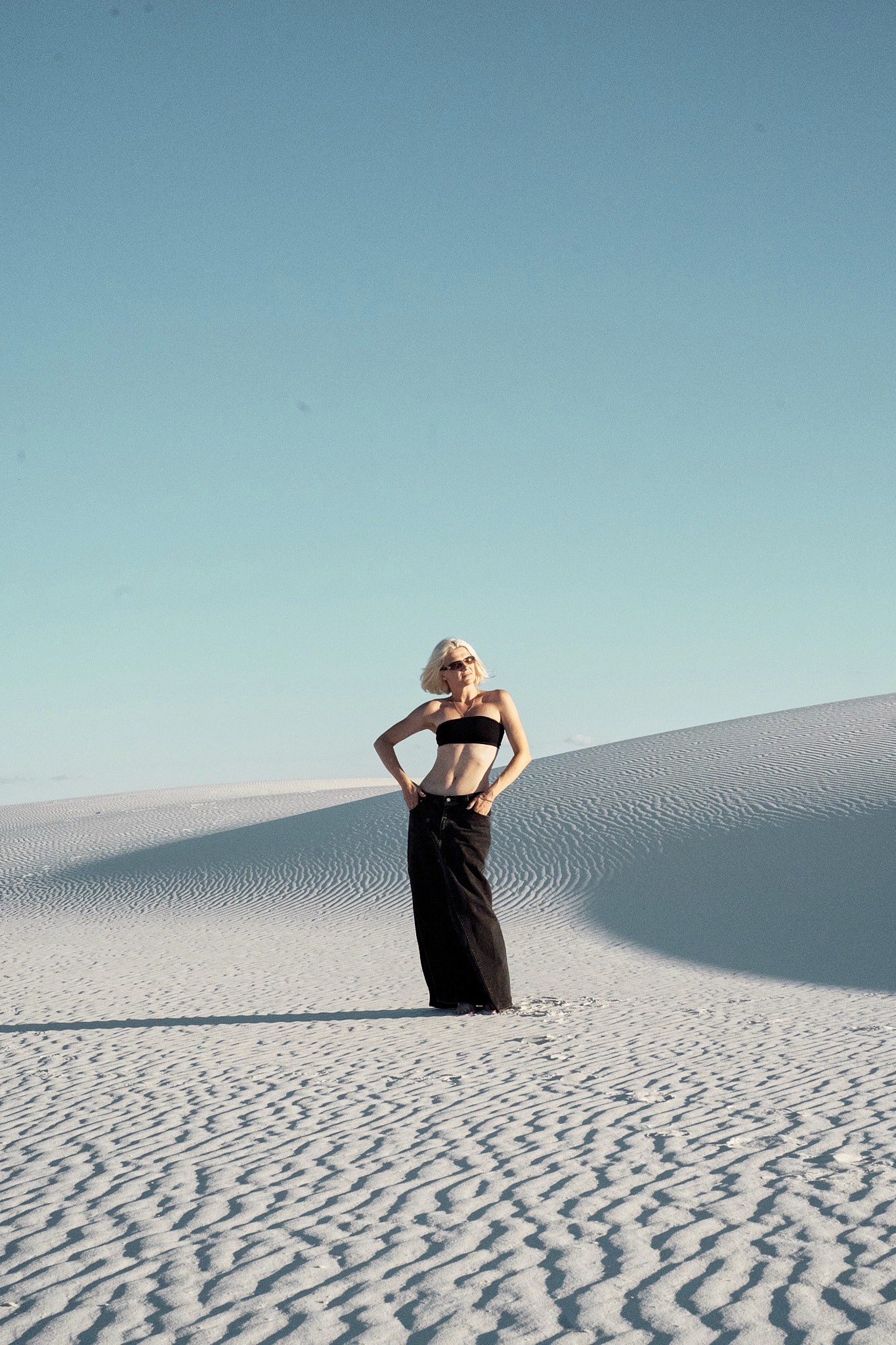 Creator Krys standing on white gypsum dunes at White Sands National Park, New Mexico — natural light minimalist portrait by Sixtynice photography