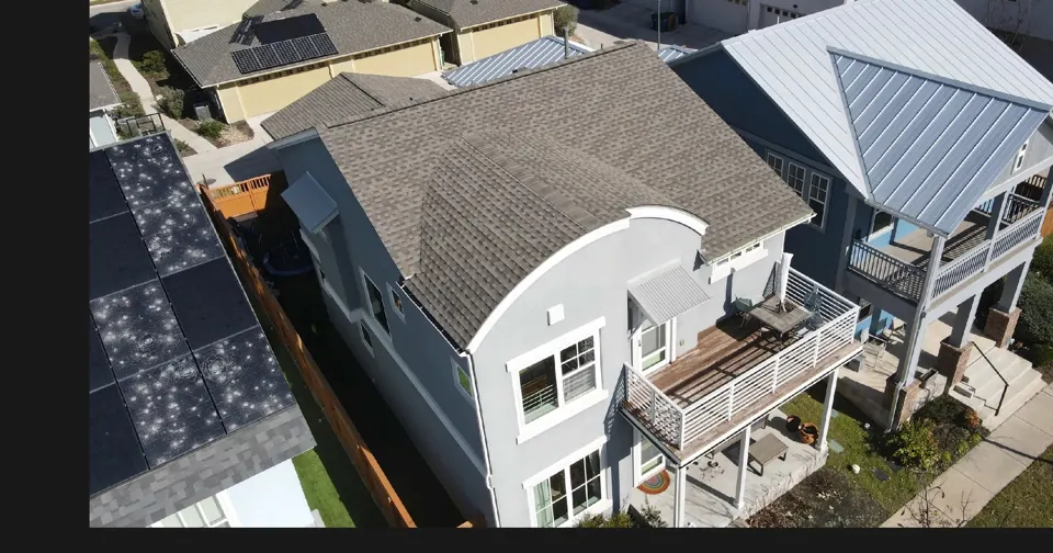 Drone view: Austin architectural shingle roof with curved front; roof overview used to introduce the installation topic.