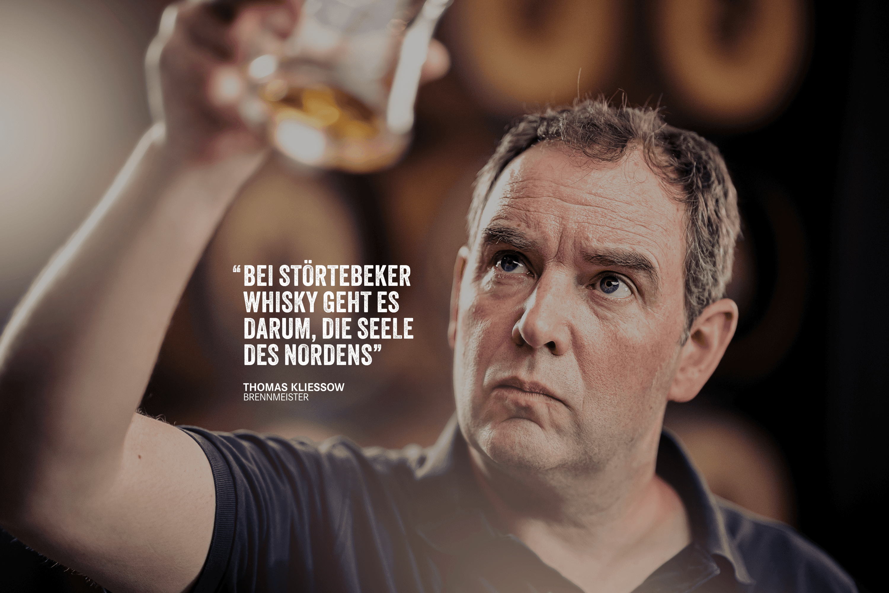 Man holding up a glass, with quote about whisky.