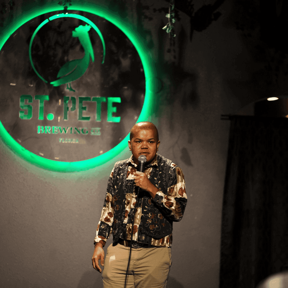 A male comedian taking control of the stage at a St Pete Standup show