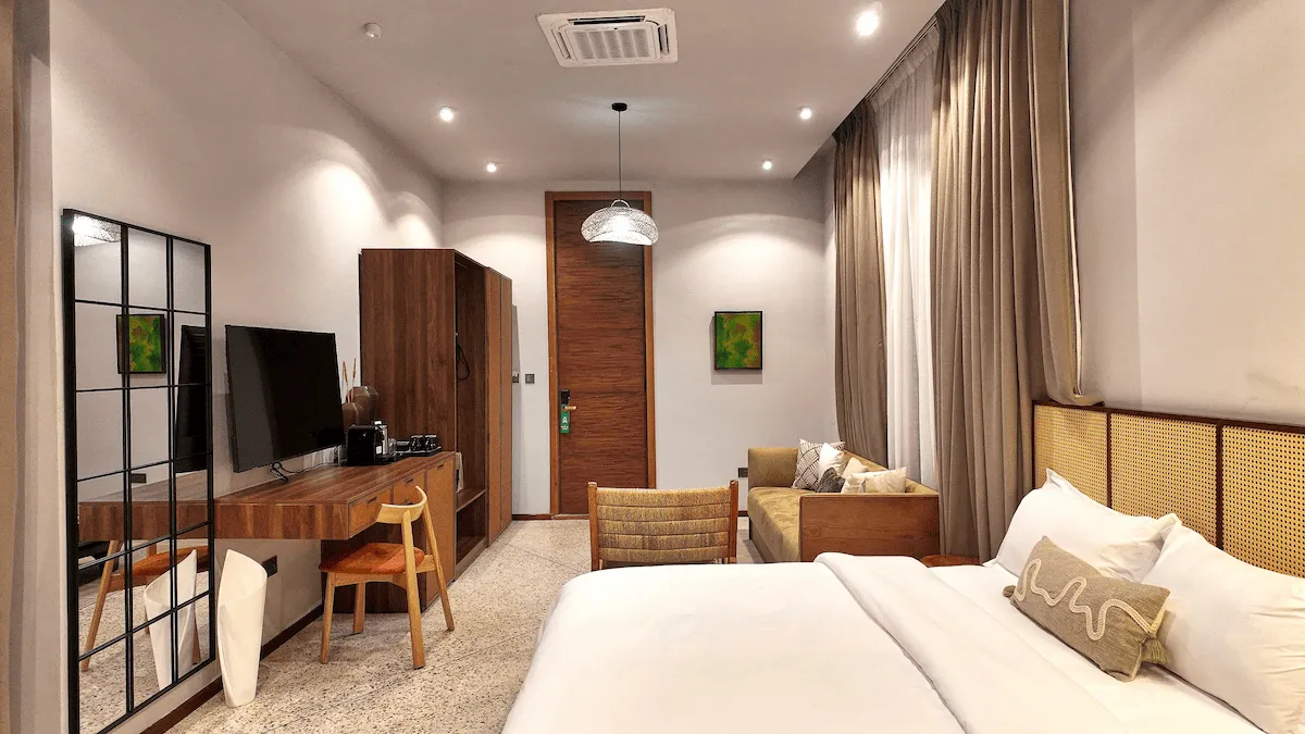 wide shot room with beds, desk, seating area