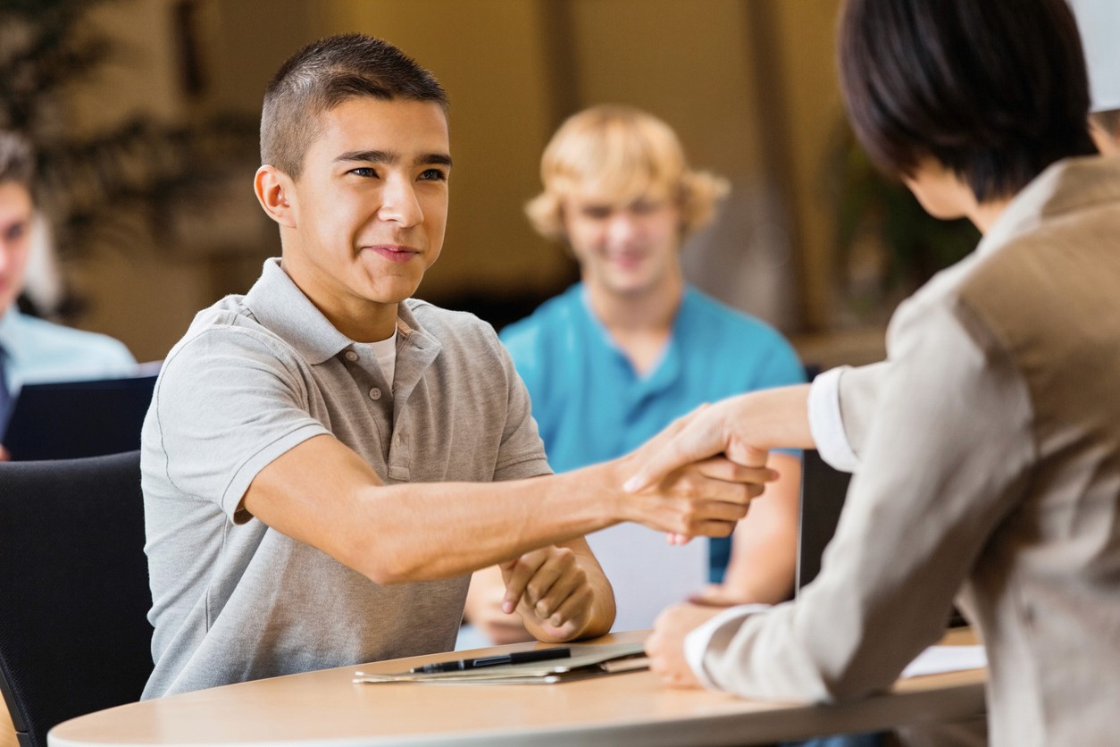 Young man at job fair with event marketing materials