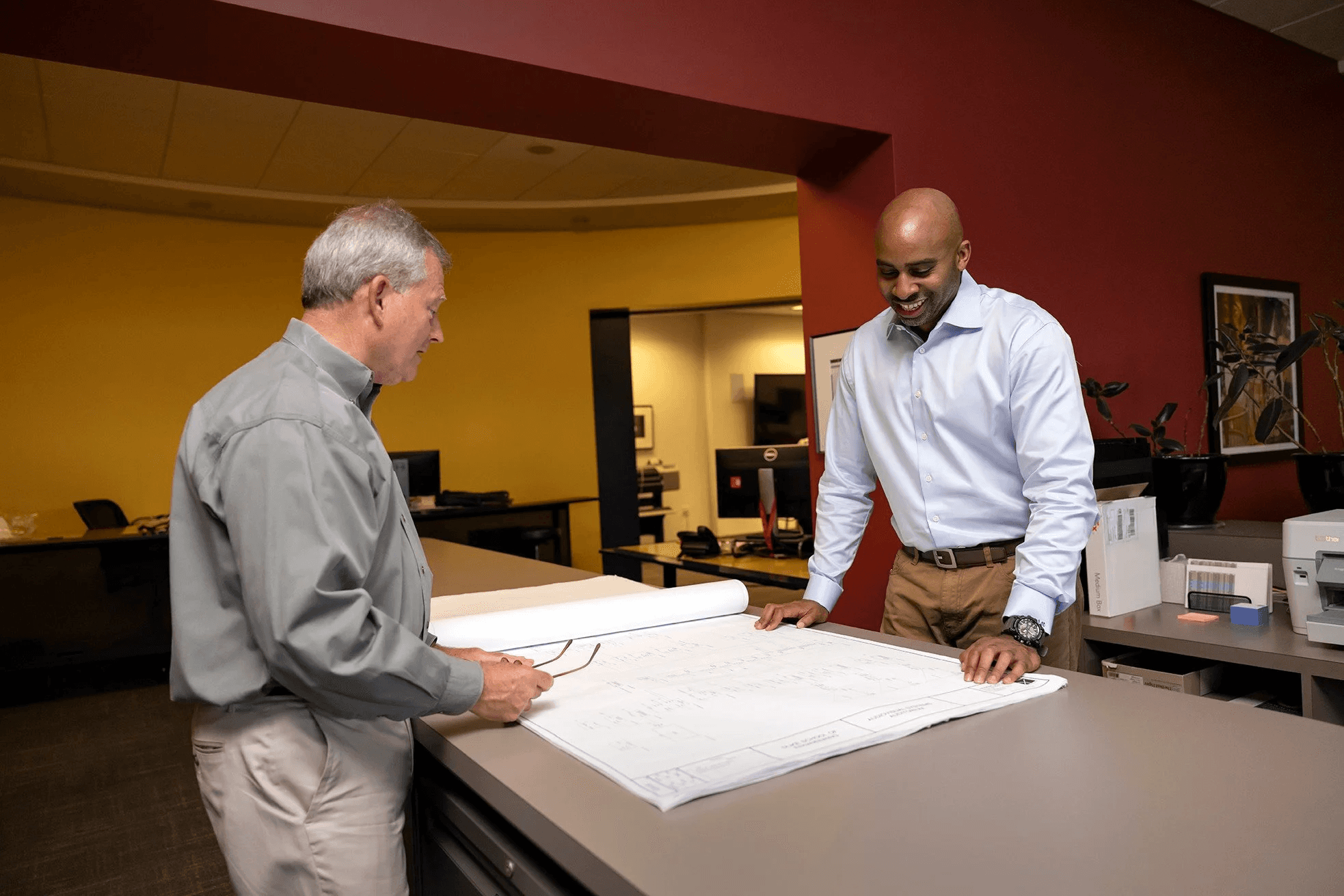 KONTEK design team reviewing AV blueprints with client