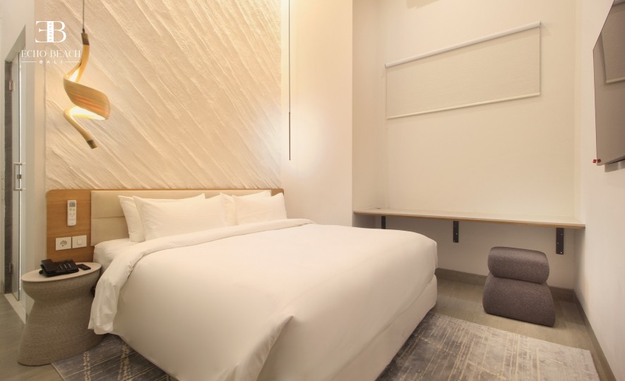 Inviting second bedroom in the three bathroom apartment at Echo Beach Suite, Canggu, Bali, with a cozy bed and ample natural light.