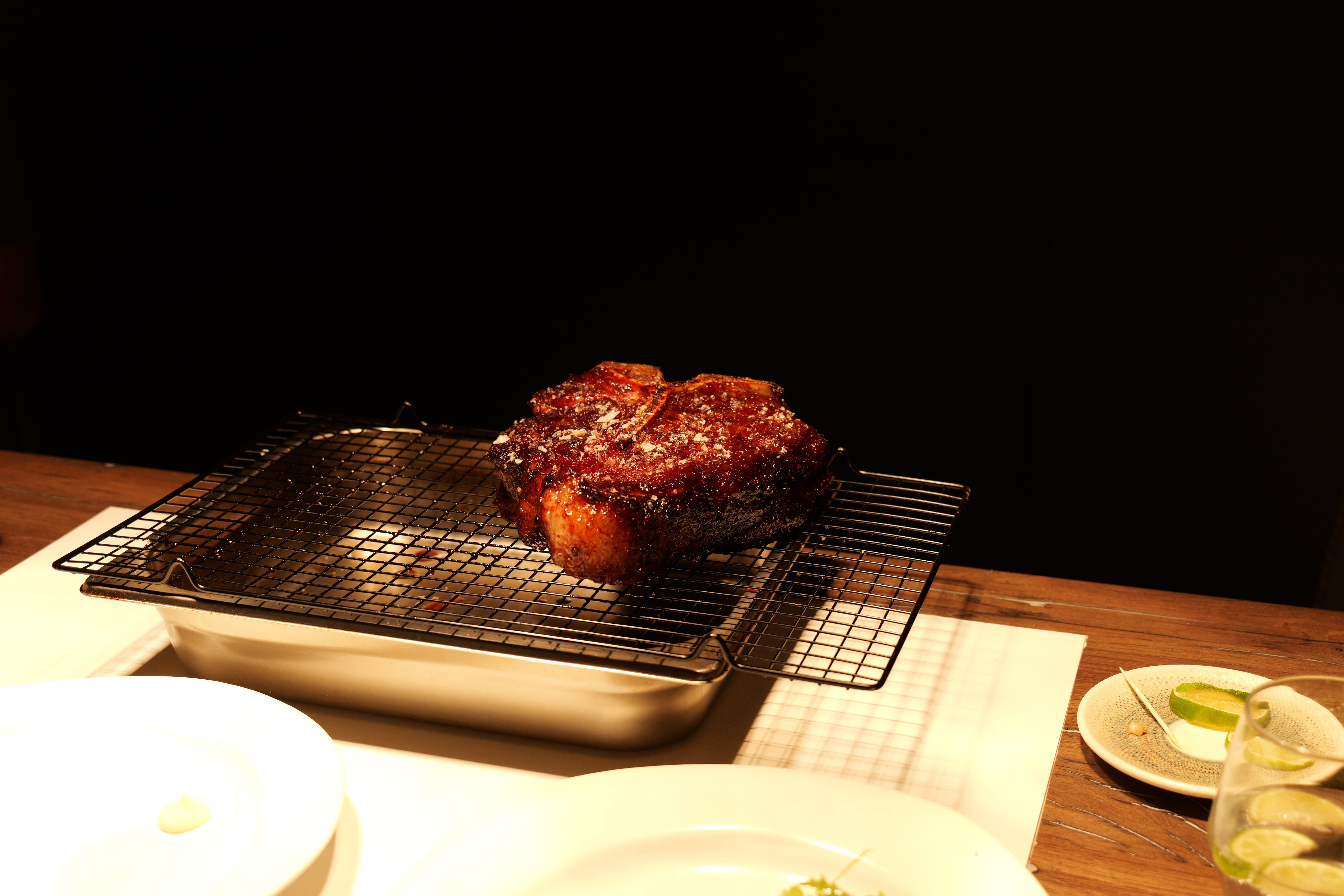 Freshly baked Margherita pizza with melted cheese, tomato sauce, and basil leaves, held by a person’s hand.