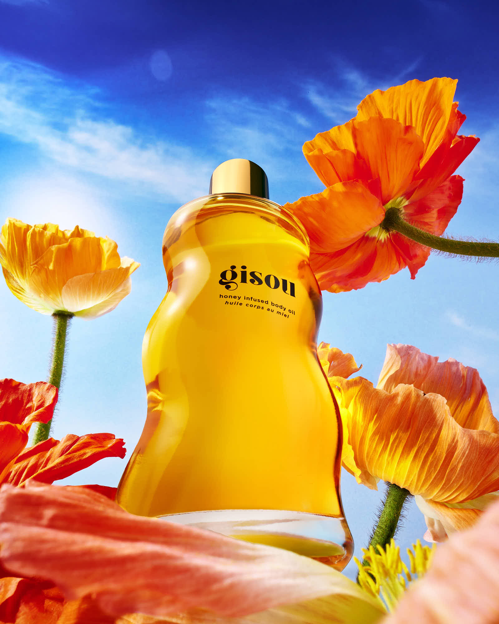 A bright yellow cos surrounded by vibrant flowers against a blue sky background.