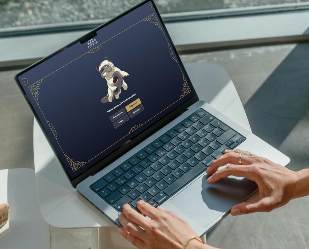 A user interacting with the Bending Quiz on a laptop, contemplating a question to 'Pick an animal companion' featuring Appa the flying bison.