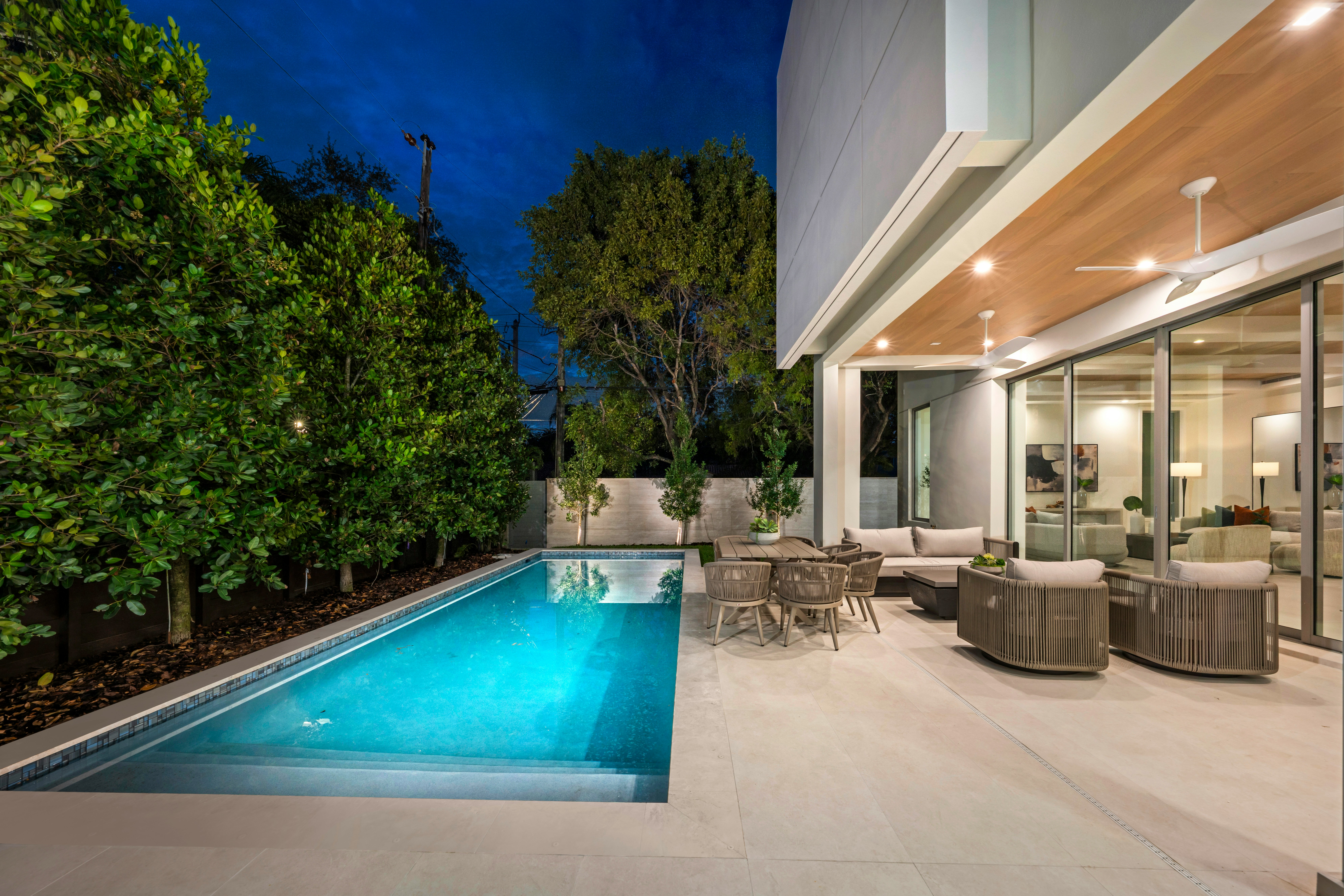 Modern home with pool and outdoor seating area.