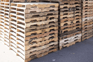 clothes iron, hammer, axe, flashlight and pitcher on brown wooden table