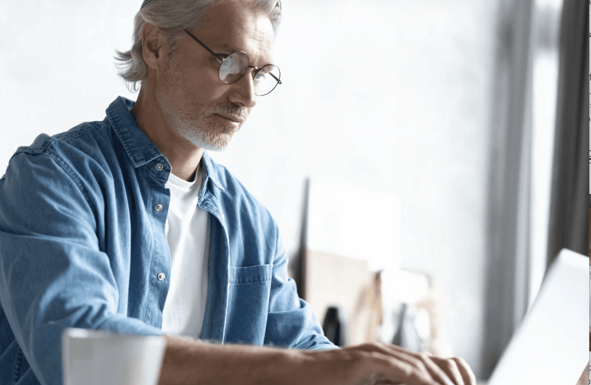 older man looking at laptop