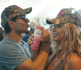 ladies with cans of hard seltzer