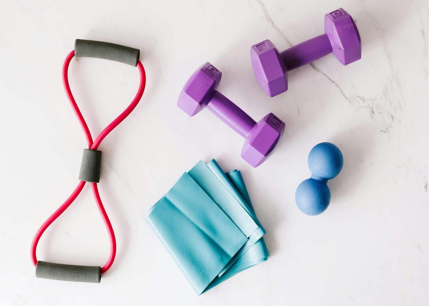 Fitness equipment of various colors and sizes laying on the floor
