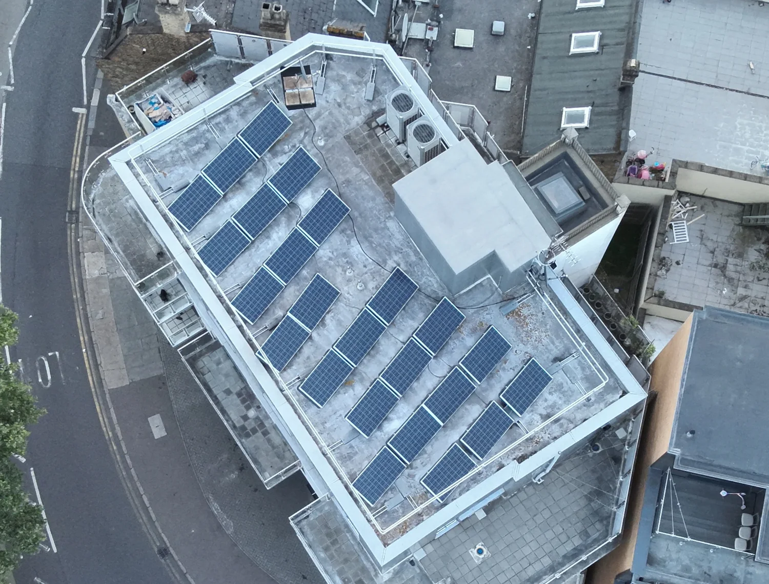 Top-down aerial drone shot of a flat roof installation conducted during a comprehensive solar panel survey