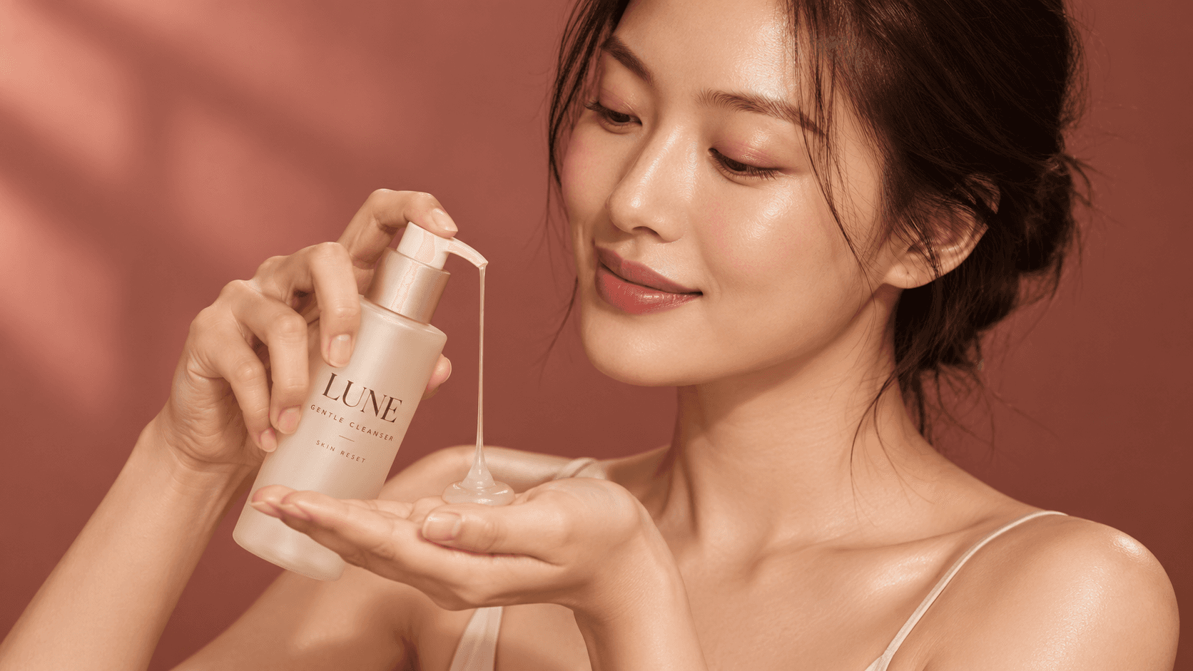 A woman applying LUNE skincare