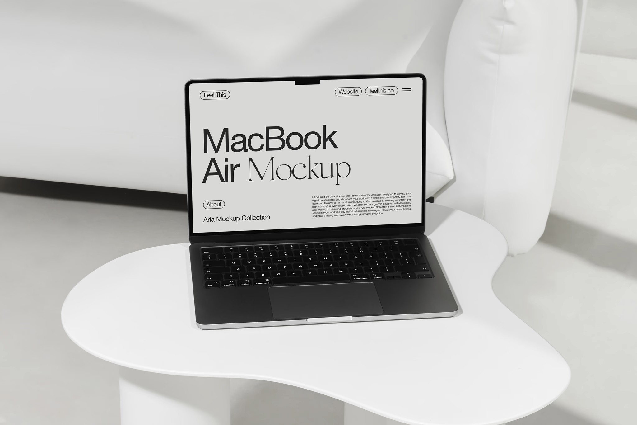 A space gray MacBook Air displayed on a modern white curved table with a minimalistic interior backdrop. The screen shows a customizable mockup interface, emphasizing clean typography and design.