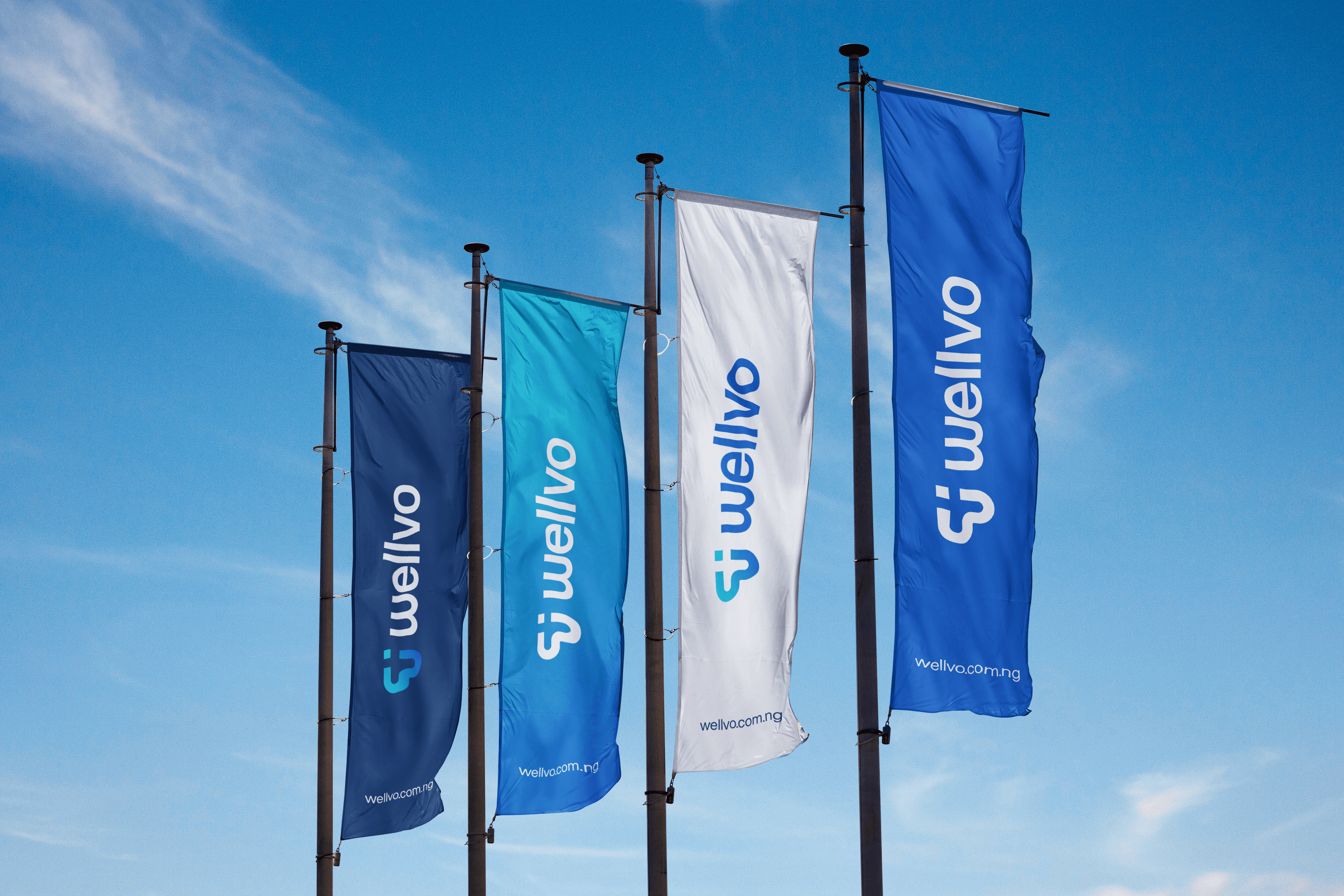 Mockup of four vertical banner flags in shades of blue and white flying against a clear blue sky.