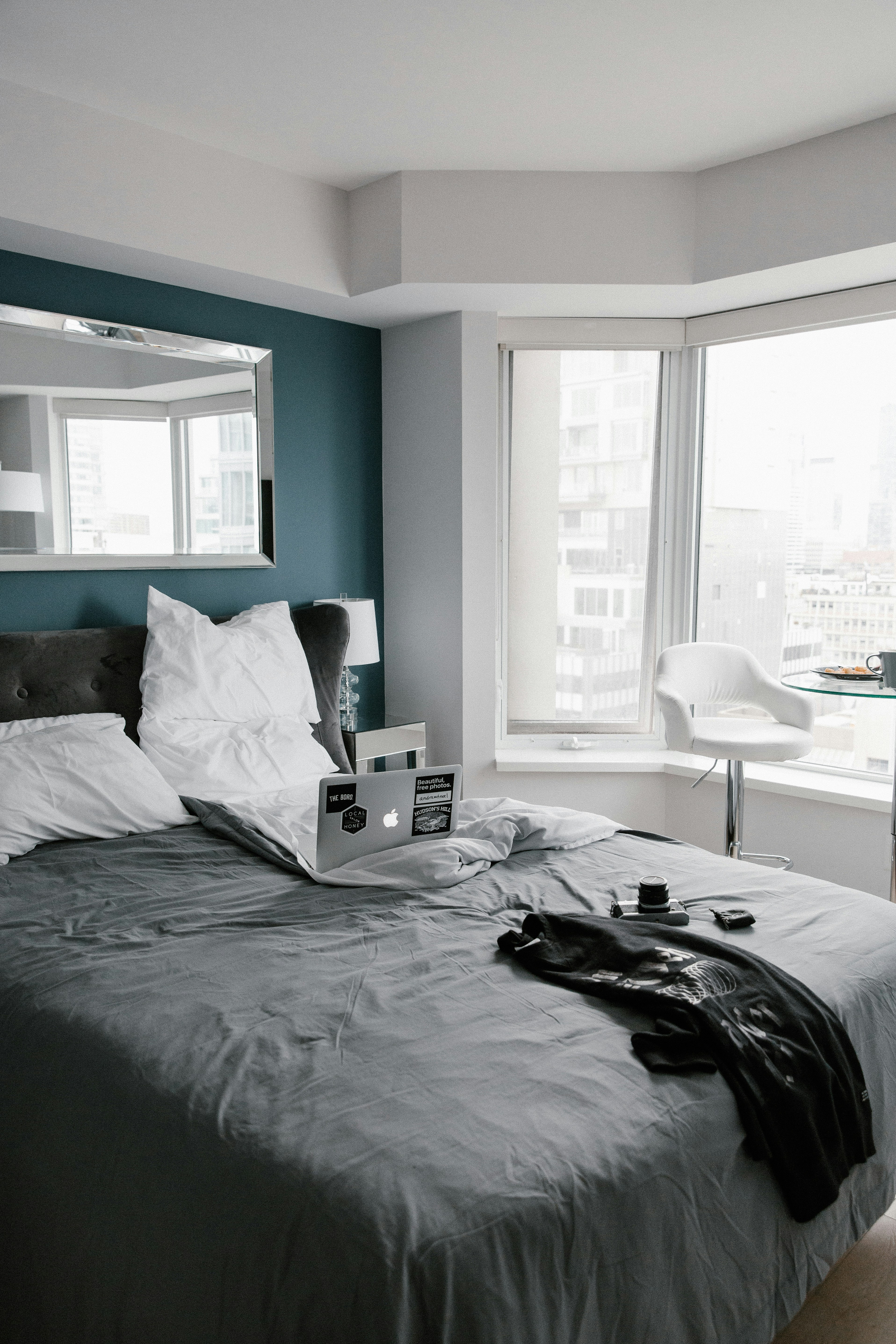 Bedroom with a bay window and neutral color palette.