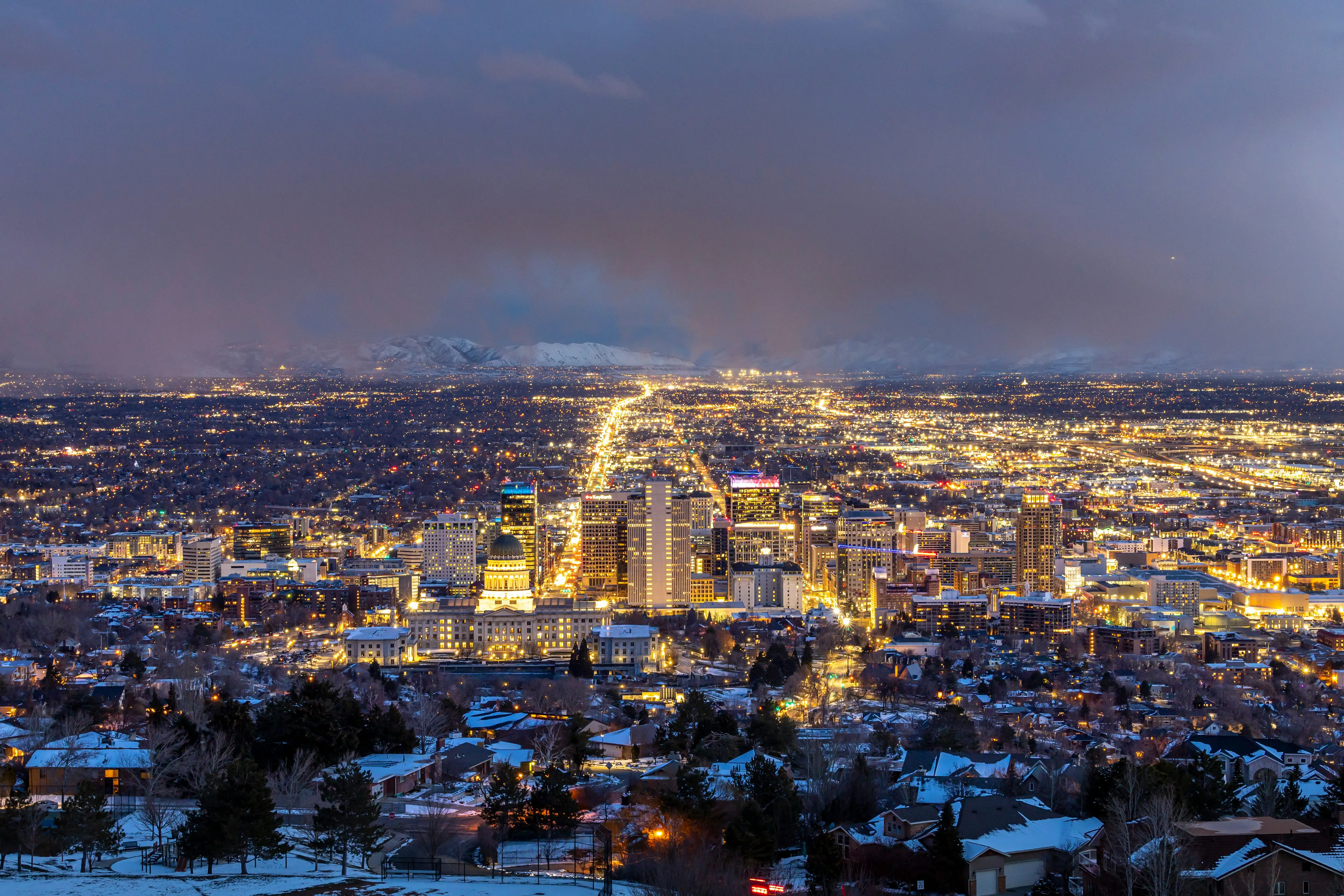 a view of a city at night from a hill