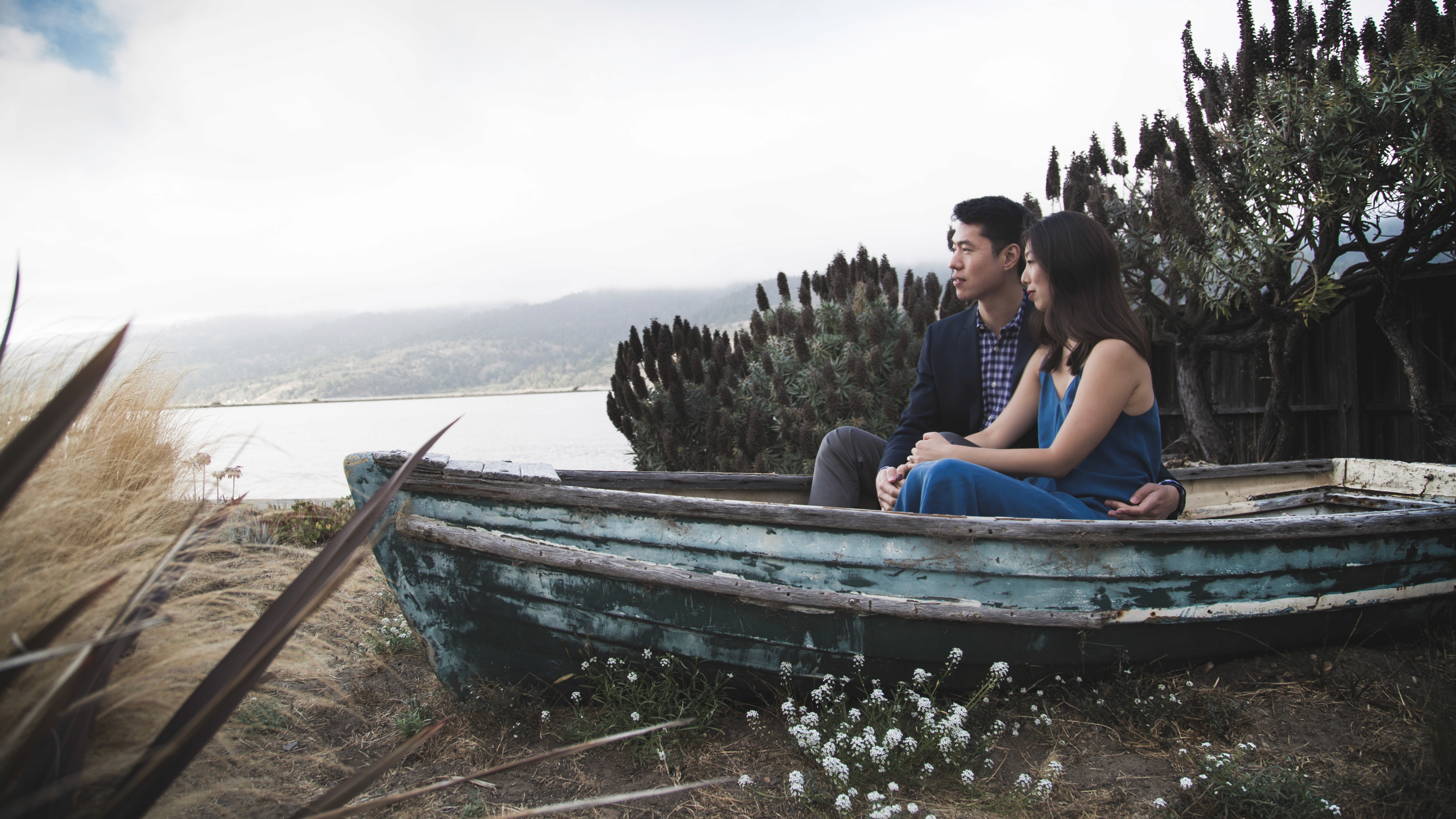 Couple sitting in a boat on shore